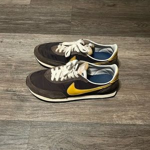 Brown and yellow Nike running shoes